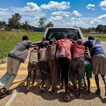 folks pushing a car